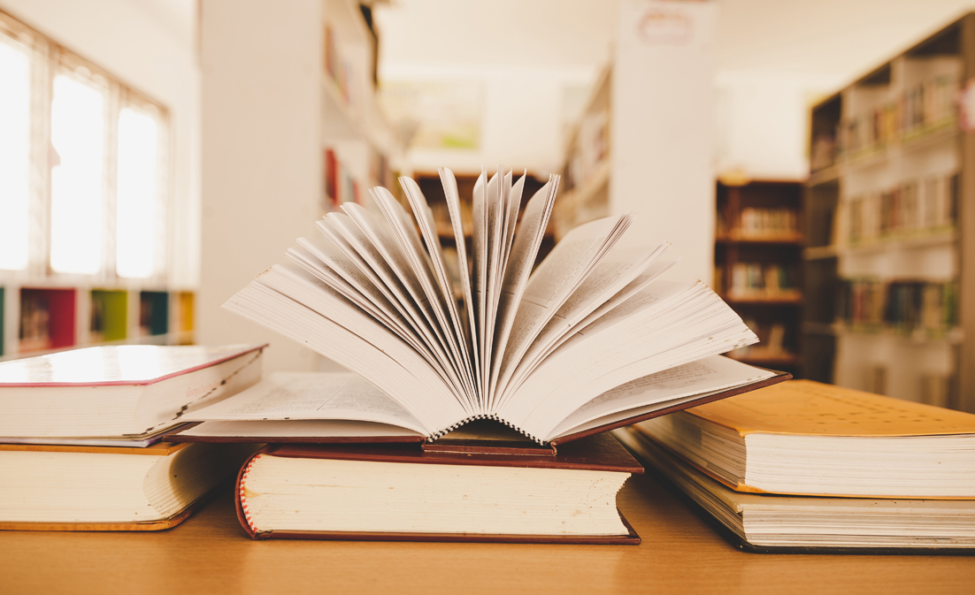 book library with old open textbook stack piles literature text archive reading desk