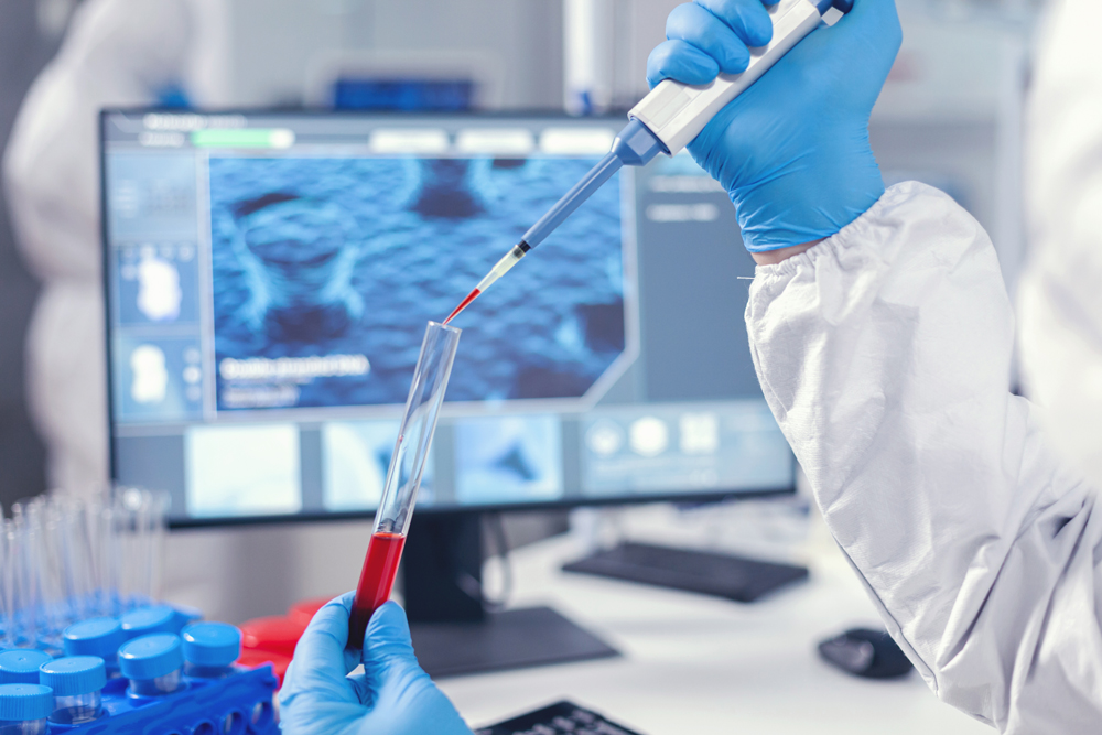 medical researcher dripping blood into a test tube from a micropipette doctor working with various bacteria and tissue pharmaceutical research for antibiotics against covid19