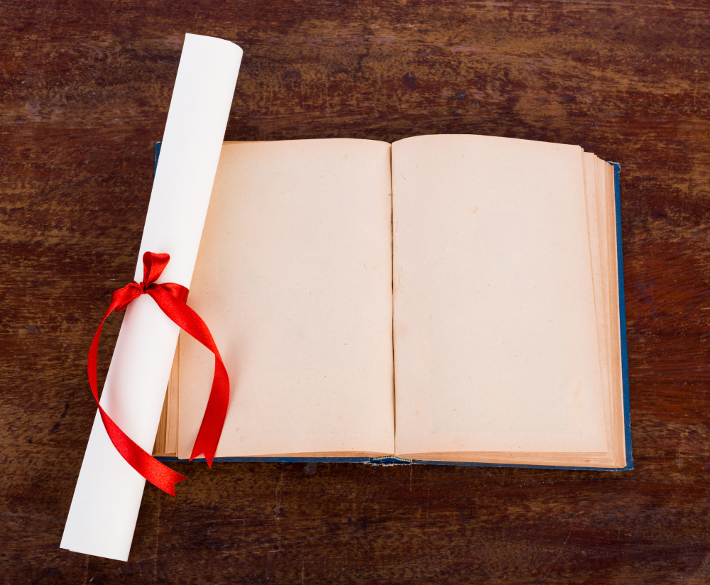 diploma with old book isolated on a white background